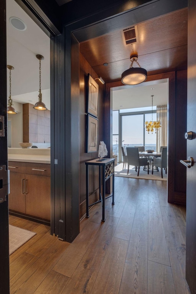 hall with visible vents and hardwood / wood-style flooring