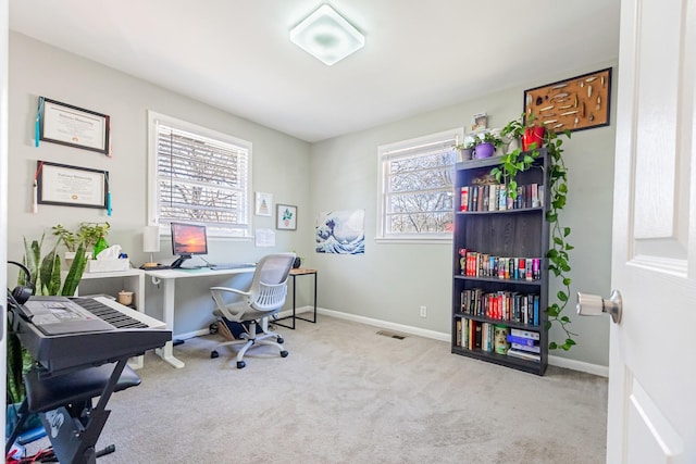 carpeted office space featuring visible vents and baseboards