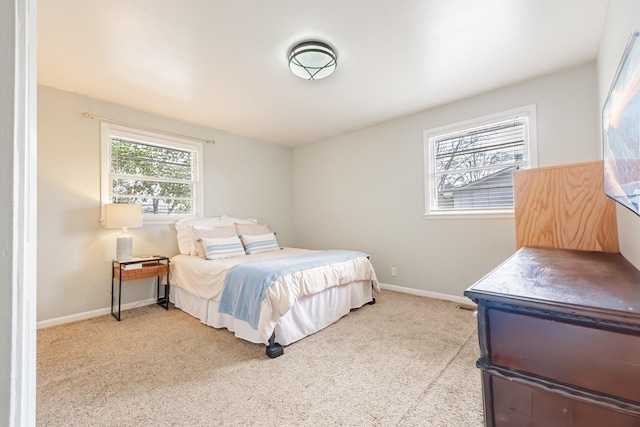 carpeted bedroom featuring baseboards