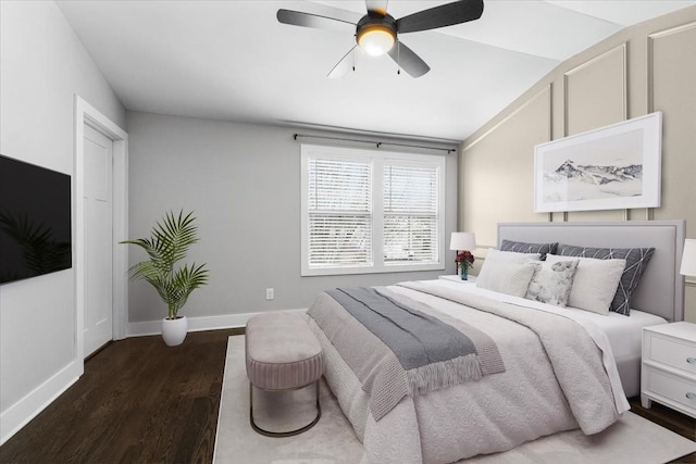 bedroom featuring baseboards, dark wood-type flooring, and ceiling fan