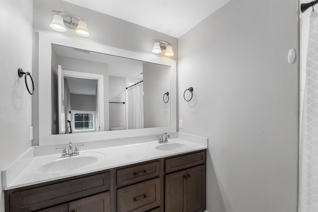 full bath featuring a sink and double vanity