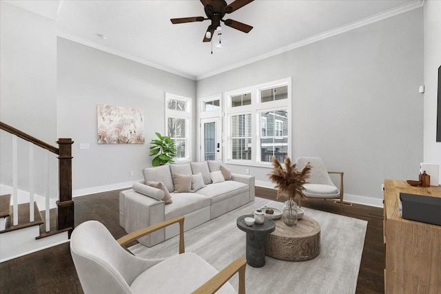 living area with baseboards, dark wood-style flooring, stairs, and ornamental molding