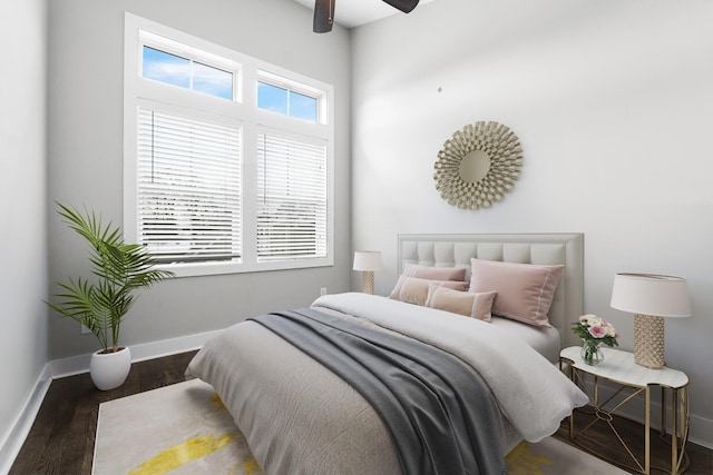 bedroom featuring a ceiling fan, wood finished floors, and baseboards