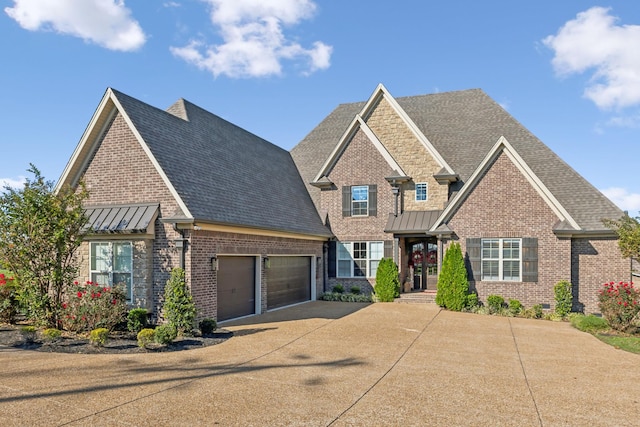 craftsman inspired home with brick siding, a shingled roof, a garage, driveway, and a standing seam roof