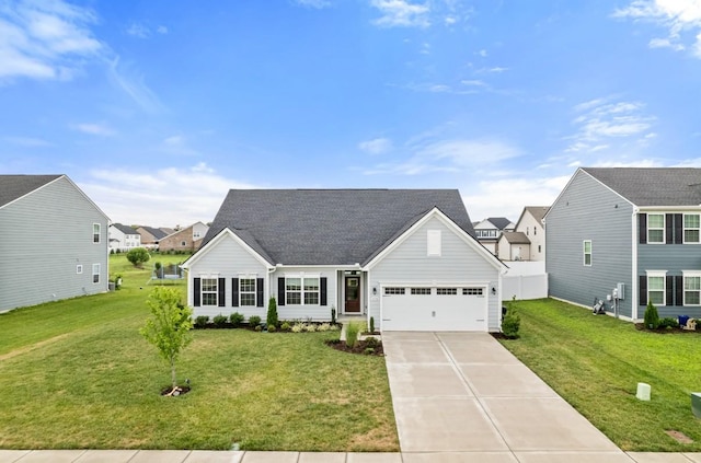 view of front of house with a garage, driveway, a front lawn, and roof with shingles