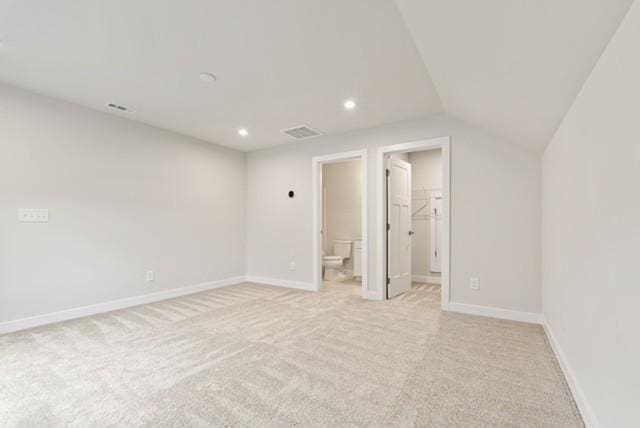 interior space with recessed lighting, baseboards, light colored carpet, and lofted ceiling