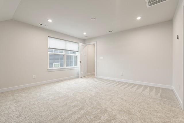 unfurnished room featuring recessed lighting, light colored carpet, visible vents, and baseboards