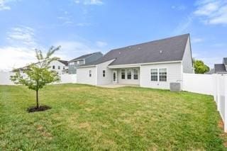 rear view of property with a yard, a patio, and a fenced backyard