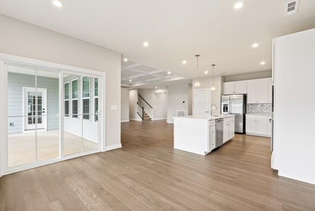 kitchen featuring visible vents, recessed lighting, stainless steel appliances, open floor plan, and light wood-type flooring