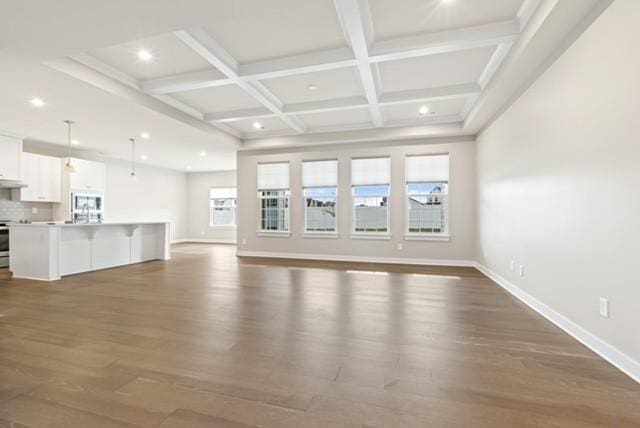 unfurnished living room with beamed ceiling, baseboards, dark wood-style flooring, and coffered ceiling