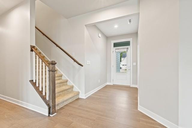 foyer with recessed lighting, wood finished floors, and baseboards