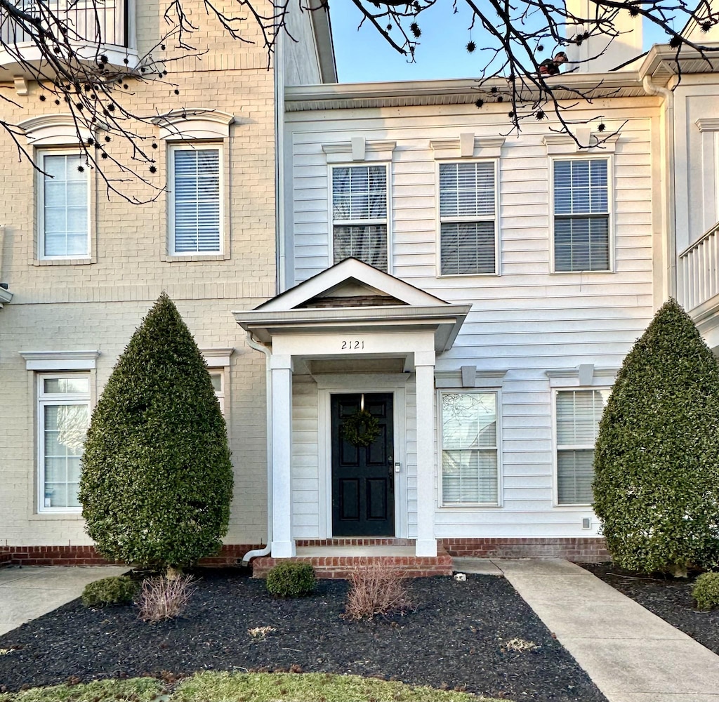 entrance to property featuring brick siding