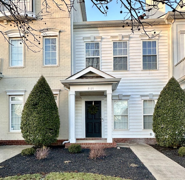 entrance to property featuring brick siding