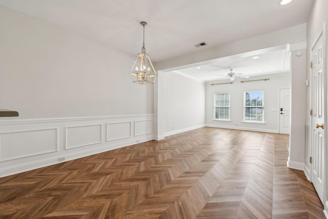 spare room featuring visible vents, a wainscoted wall, ceiling fan with notable chandelier, recessed lighting, and a decorative wall