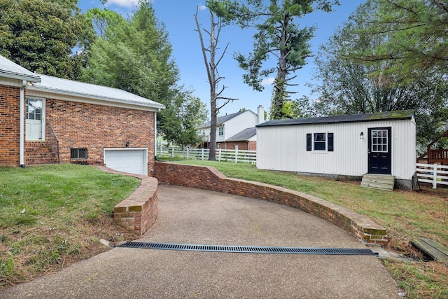 exterior space with a yard, brick siding, concrete driveway, and fence