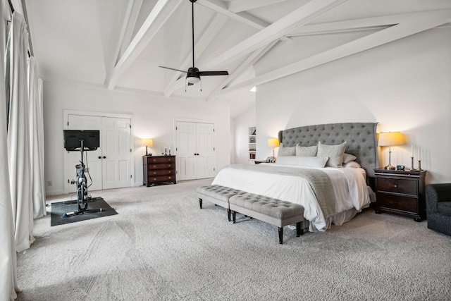 bedroom featuring beamed ceiling, multiple closets, high vaulted ceiling, carpet flooring, and ceiling fan