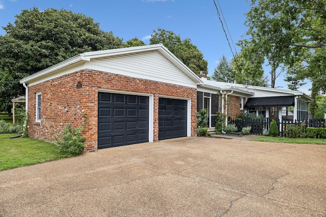 ranch-style house featuring a front yard, brick siding, an attached garage, and driveway