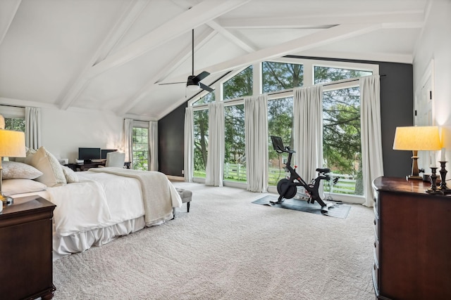 carpeted bedroom featuring multiple windows, a ceiling fan, and vaulted ceiling with beams