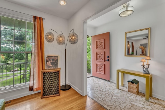 foyer with visible vents, baseboards, and wood finished floors