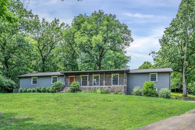 single story home with brick siding, a porch, and a front yard