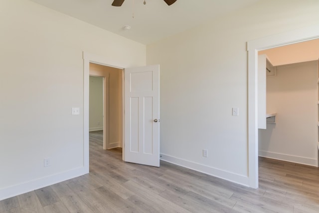 unfurnished bedroom featuring baseboards and light wood-style flooring