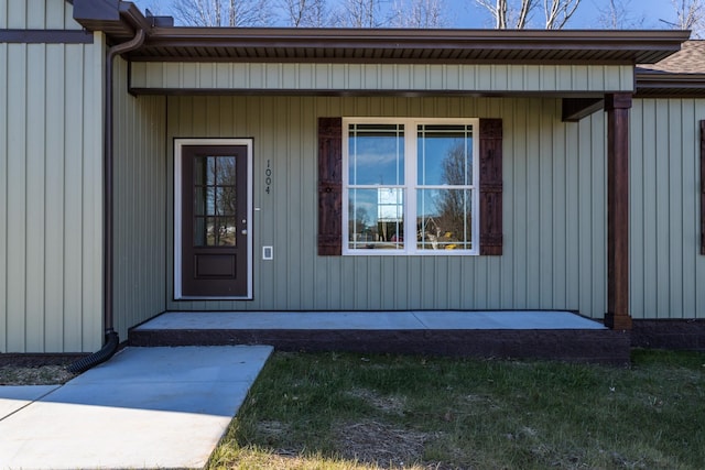 doorway to property with board and batten siding and covered porch