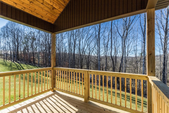 wooden deck with a yard and a wooded view