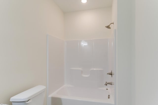 bathroom featuring shower / bathing tub combination and toilet