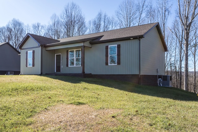 single story home with a front yard, central AC unit, and roof with shingles