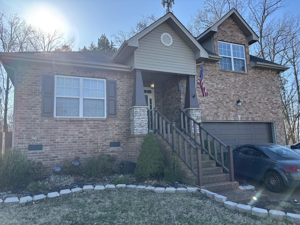 view of front facade featuring crawl space, an attached garage, and brick siding