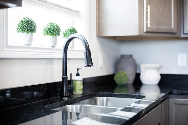 room details with dark countertops and a sink