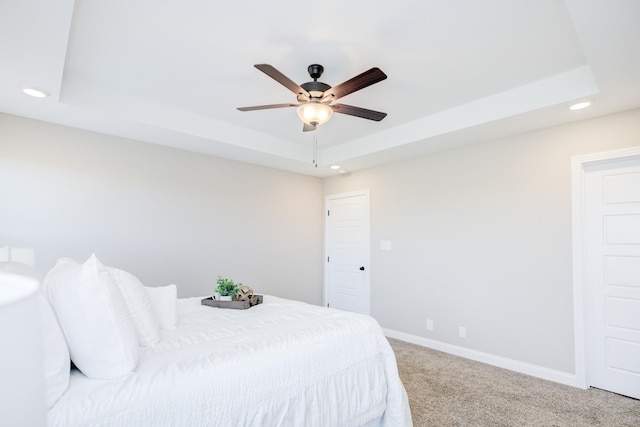 carpeted bedroom featuring recessed lighting, a ceiling fan, a raised ceiling, and baseboards