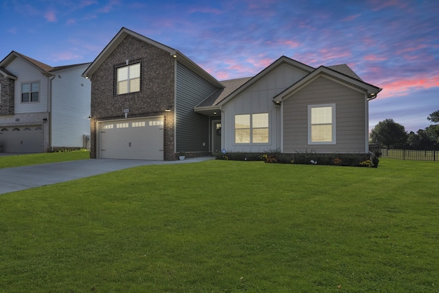 view of front of home featuring board and batten siding, concrete driveway, a front lawn, and fence