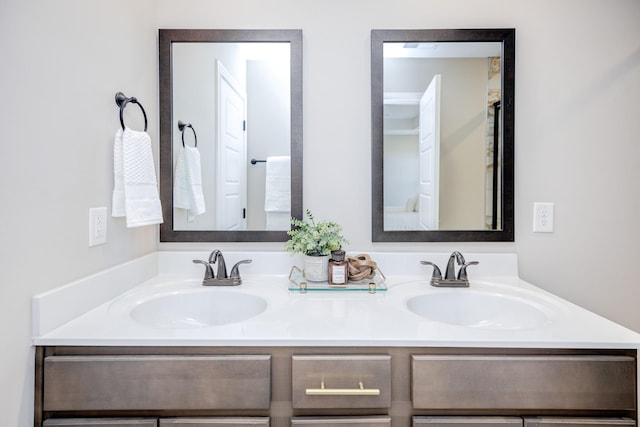 full bathroom with double vanity and a sink