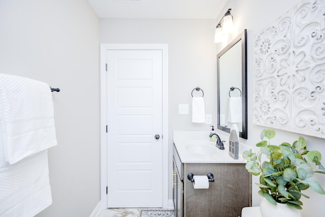 half bath with visible vents, baseboards, toilet, and vanity