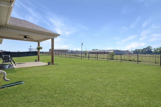 view of yard featuring a fenced backyard, a patio area, and ceiling fan