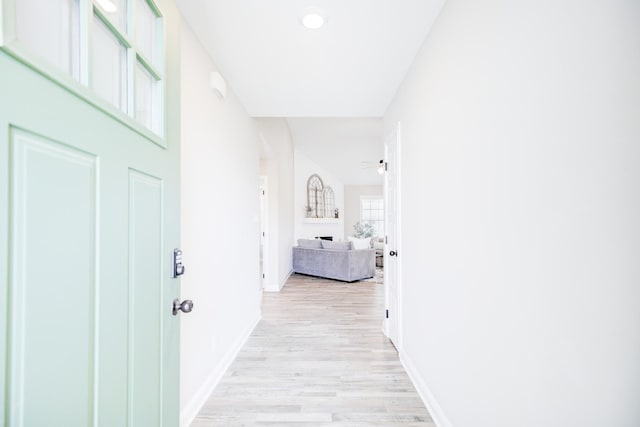 hall with recessed lighting, baseboards, and light wood-style flooring