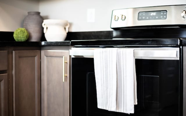 kitchen featuring dark countertops and stainless steel range with electric cooktop