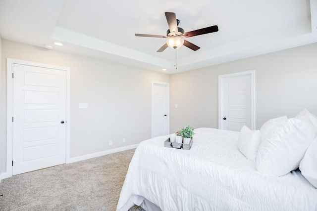 carpeted bedroom featuring recessed lighting, a ceiling fan, a raised ceiling, and baseboards