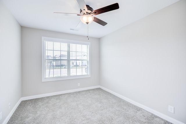 empty room with visible vents, baseboards, carpet flooring, and a ceiling fan