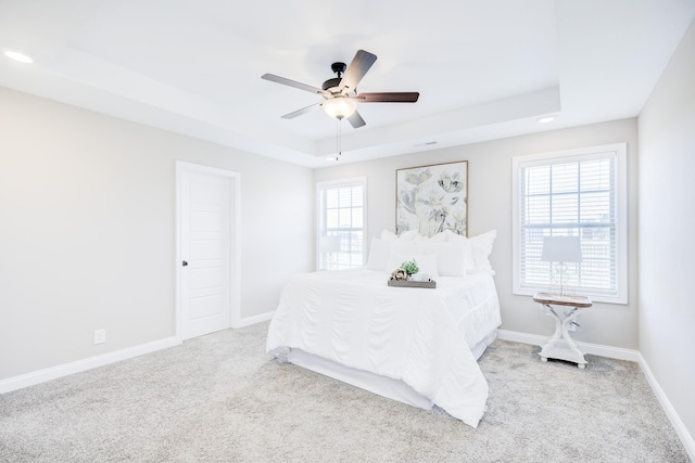 bedroom with carpet, baseboards, recessed lighting, ceiling fan, and a raised ceiling