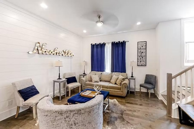 living area with stairway, recessed lighting, wood finished floors, and baseboards