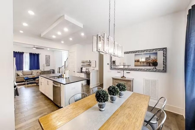 dining room featuring visible vents, dark wood-type flooring, recessed lighting, baseboards, and stairs