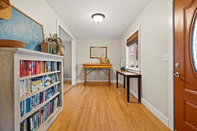 hall featuring wood finished floors and baseboards