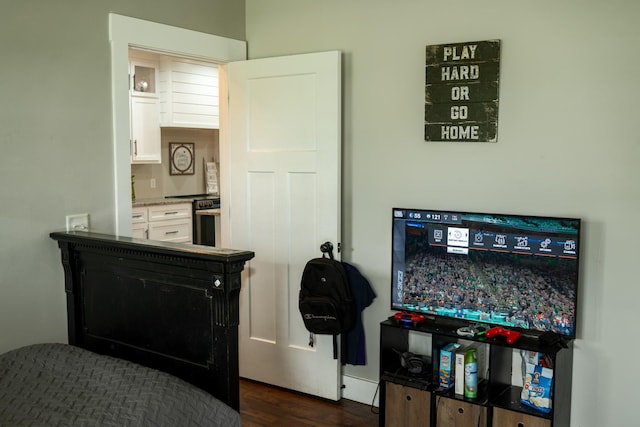 bedroom with dark wood-type flooring