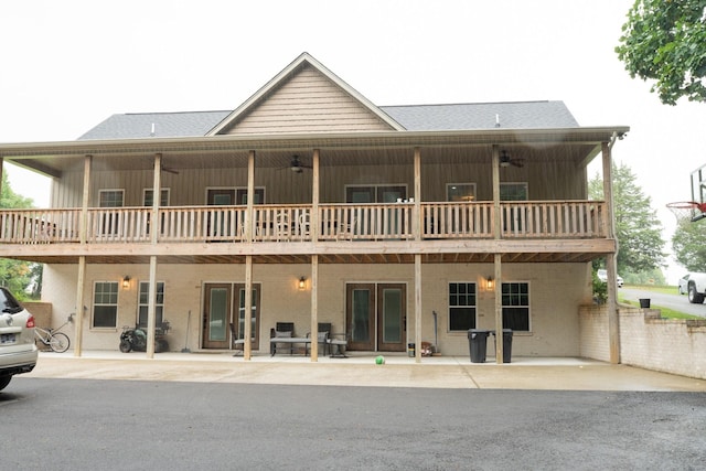 rear view of property featuring a patio and board and batten siding