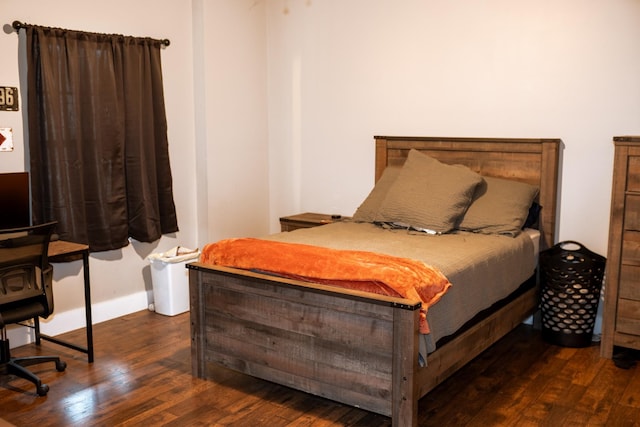 bedroom featuring baseboards and hardwood / wood-style floors