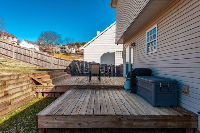 deck featuring outdoor dining area, fence, and a residential view