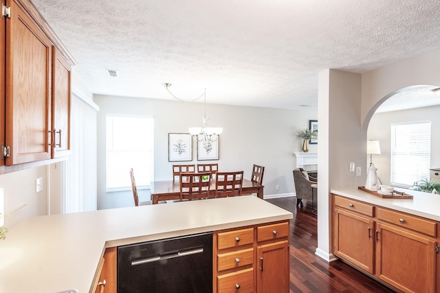 kitchen with dishwashing machine, visible vents, dark wood finished floors, a peninsula, and light countertops