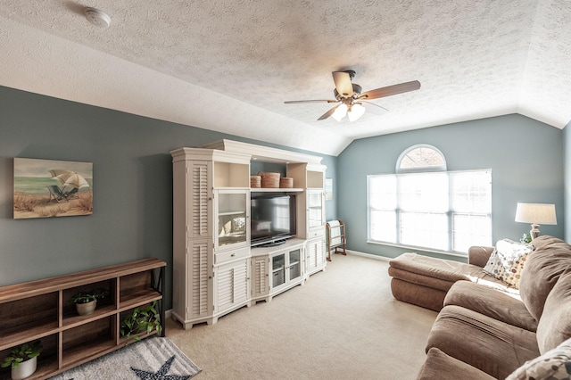 living area with carpet flooring, ceiling fan, a textured ceiling, and lofted ceiling